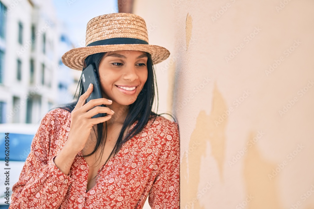 Young african american tourist woman on vacation talking on the smartphone at the city. Young african american tourist woman on vacation talking on the smartphone at the city.