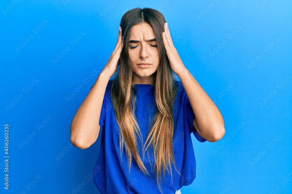 Young hispanic woman wearing casual clothes with hand on head for pain in head because stress. suffering migraine. Young hispanic woman wearing casual clothes with hand on head for pain in head because stress. suffering migraine.