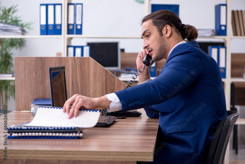 Young male employee working in the office Young male employee working in the office