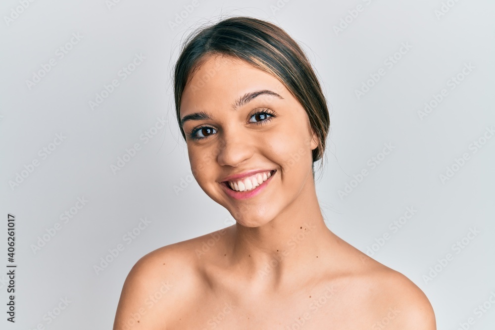 Young brunette woman standing topless showing skin looking positive and happy standing and smiling with a confident smile showing teeth Young brunette woman standing topless showing skin looking positive and happy standing and smiling with a confident smile showing teeth