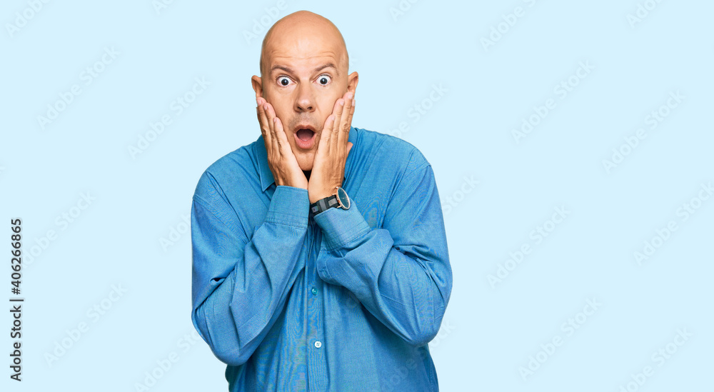 Middle age bald man wearing casual clothes afraid and shocked, surprise and amazed expression with hands on face Middle age bald man wearing casual clothes afraid and shocked, surprise and amazed expression with hands on face