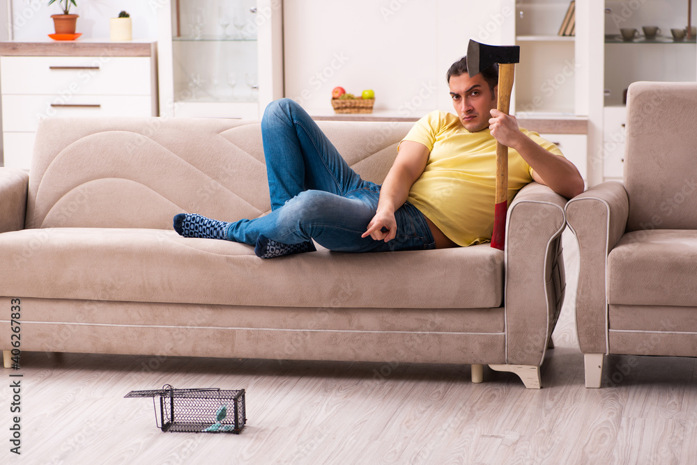 Fototapeta premium Young man and mousetrap at home