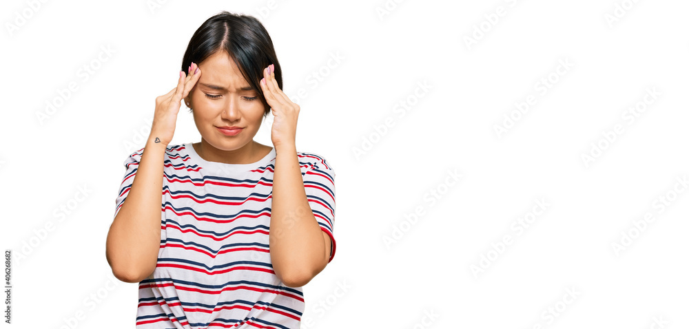 Beautiful young woman with short hair wearing casual clothes with hand on head for pain in head because stress. suffering migraine. Beautiful young woman with short hair wearing casual clothes with hand on head for pain in head because stress. suffering migraine.
