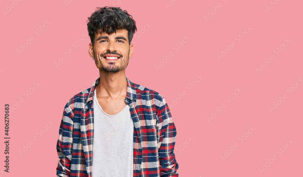 Young hispanic man wearing casual clothes with a happy and cool smile on face. lucky person. Young hispanic man wearing casual clothes with a happy and cool smile on face. lucky person.