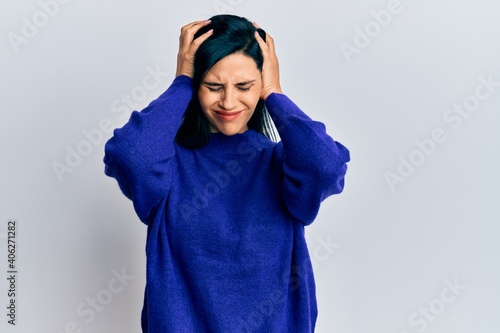 Young caucasian woman wearing casual clothes suffering from headache desperate and stressed because pain and migraine. hands on head. © Krakenimages.com
