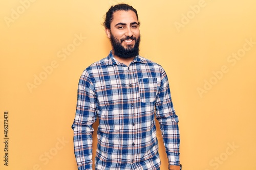 Young arab man wearing casual clothes with a happy and cool smile on face. lucky person.