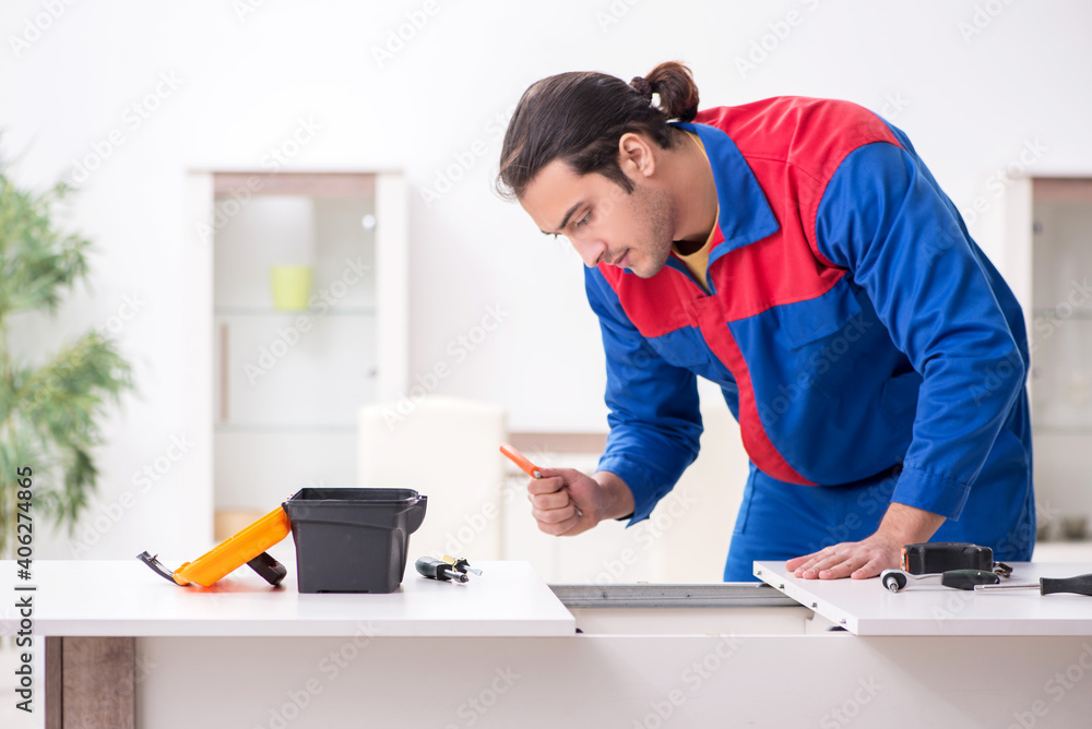 Young male carpenter working indoors Young male carpenter working indoors