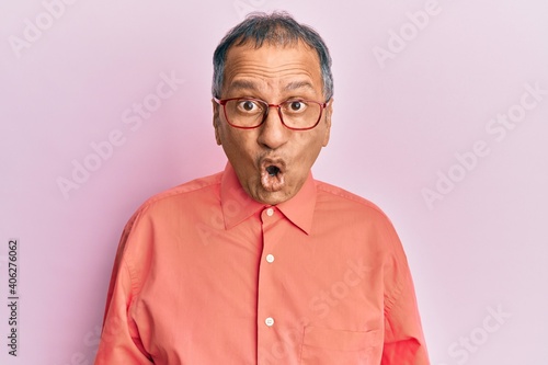 Middle age indian man wearing casual clothes and glasses afraid and shocked with surprise expression, fear and excited face. © Krakenimages.com