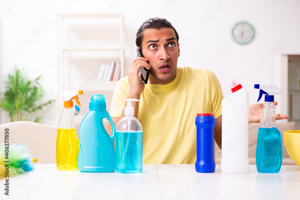 Young male contractor doing housework at home Young male contractor doing housework at home