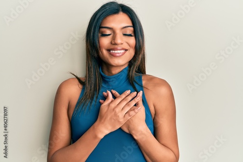 Young latin transsexual transgender woman wearing casual clothes smiling with hands on chest, eyes closed with grateful gesture on face. health concept. photo