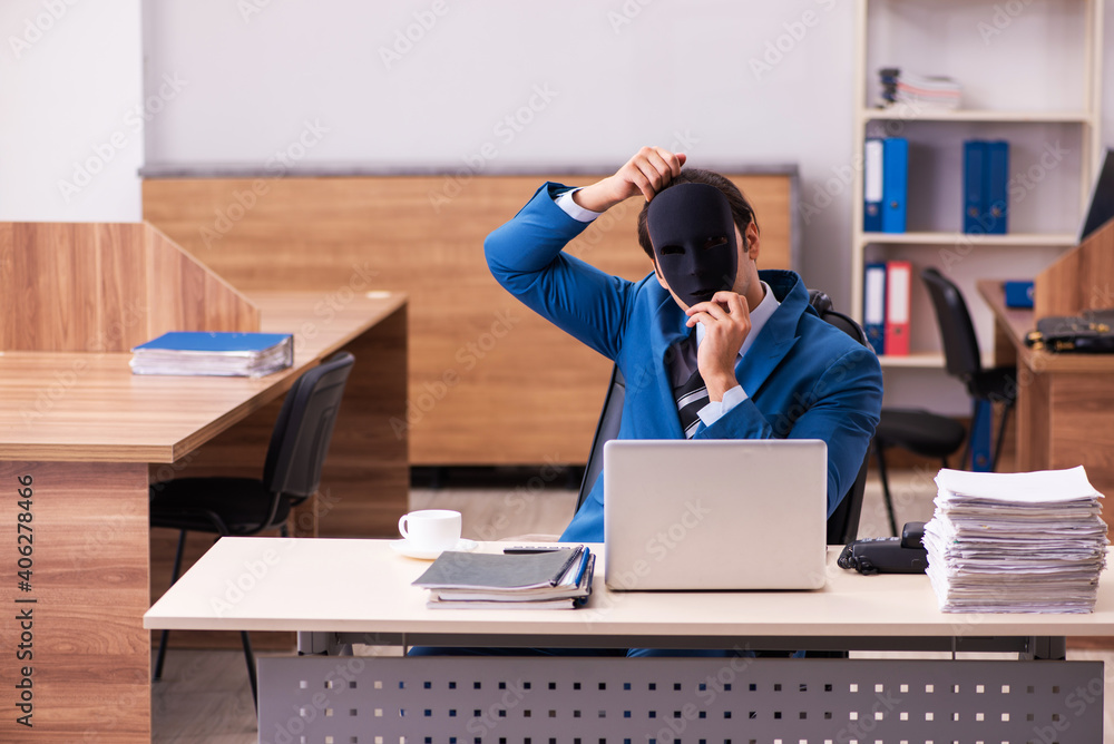 Young male employee wearing masks in the office Young male employee wearing masks in the office
