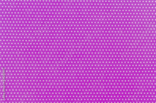 Textile background, purple violet with a print in white polka dots.