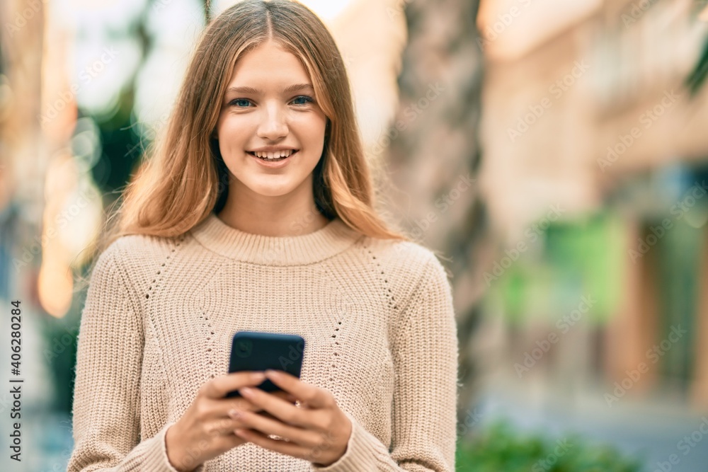 Beautiful caucasian teenager smiling happy using smartphone at the city. Beautiful caucasian teenager smiling happy using smartphone at the city.