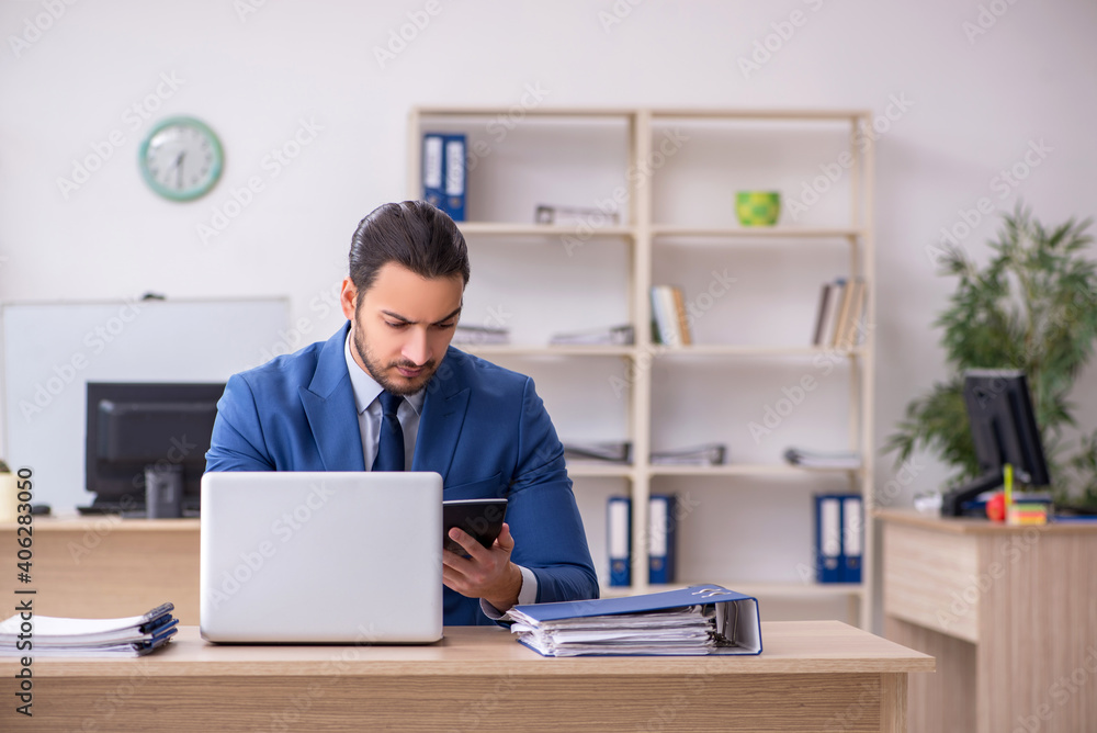 Young male businessman employee working in the office Young male businessman employee working in the office