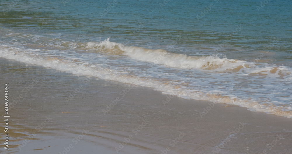 Sea wave over sand beach