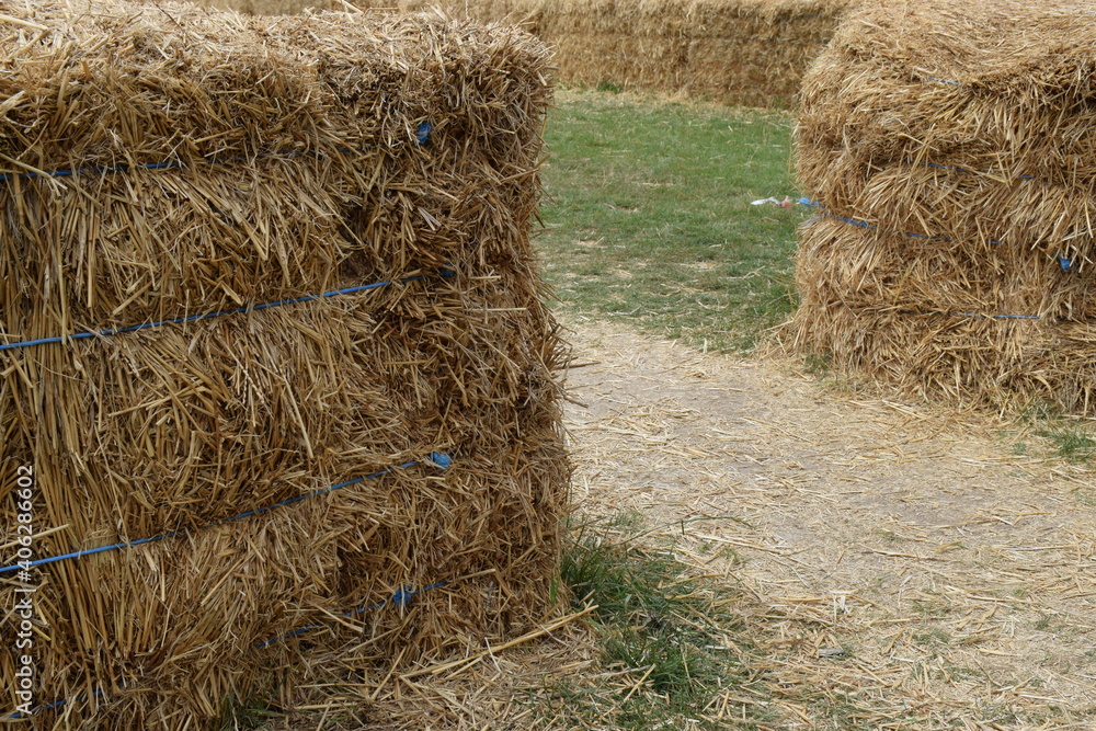 Hay bales being used for crowd control, with a pathway between two bales Hay bales being used for crowd control, with a pathway between two bales