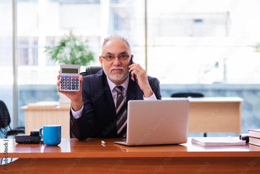 Old businessman employee working in the office Old businessman employee working in the office