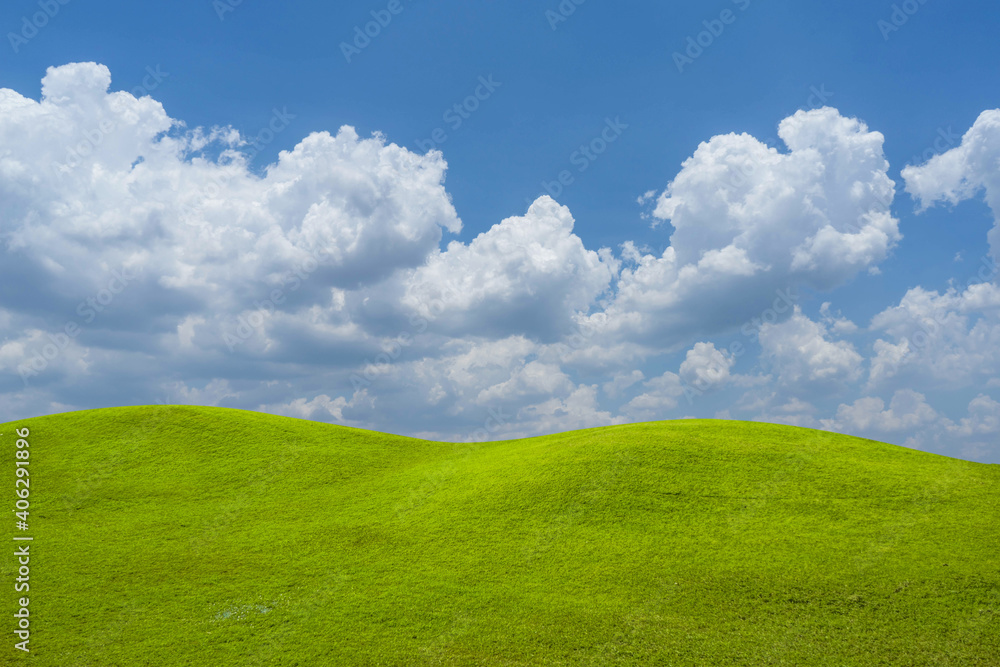 Green grass field on blue sky with cloud background. Green meadow under blue sky with clouds. Green grass field on blue sky with cloud background. Green meadow under blue sky with clouds.