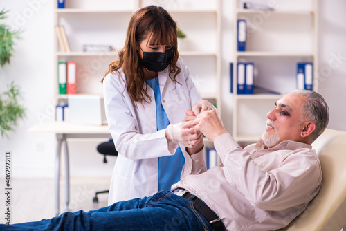 Old man visiting young female doctor for plastic surgery