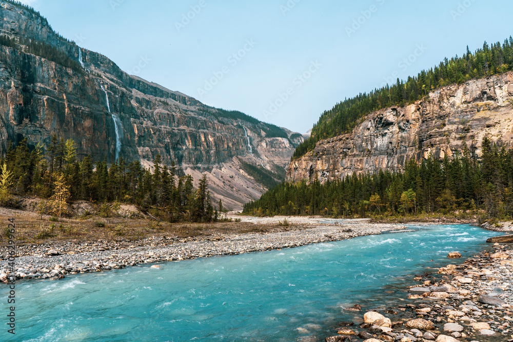 Glacial turquoise river with mountains