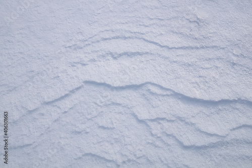 Background of fresh snow in blue tones.