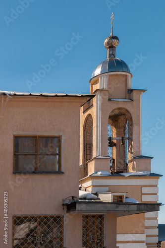 a small bell tower with a dome and a cross on the church building