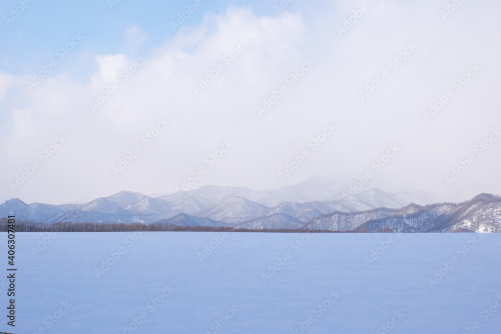 Snow-covered mountains and flowing clouds in Hokkaido, Japan