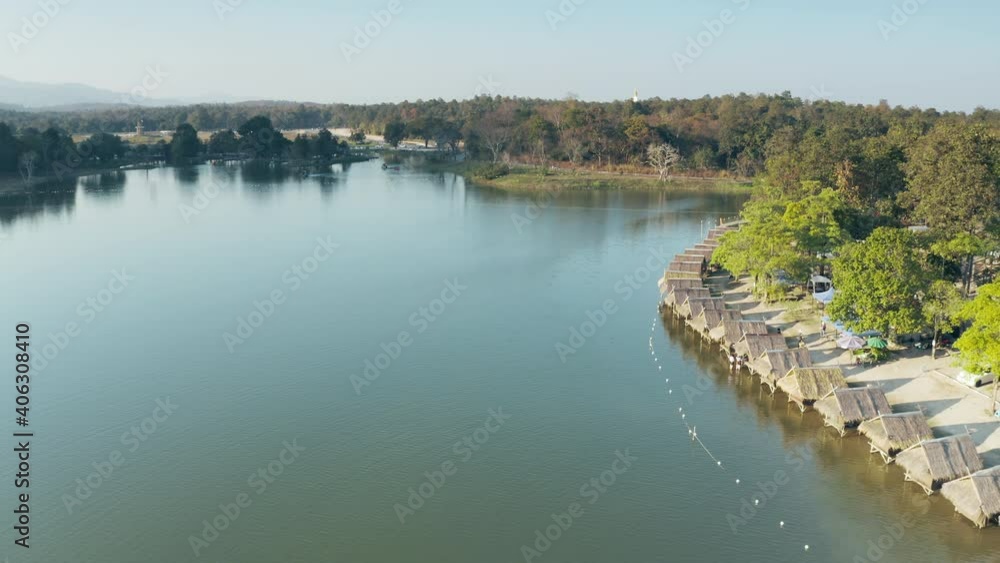 Travel place in Chiang Mai of Thailand in aerial view. Huay tung tao lake with wood or bamboo hut, floating restaurant, cafe or bungalow seating at outdoor, water's edge. Beautiful local relaxing area Travel place in Chiang Mai of Thailand in aerial view. Huay tung tao lake with wood or bamboo hut, floating restaurant, cafe or bungalow seating at outdoor, water's edge. Beautiful local relaxing area