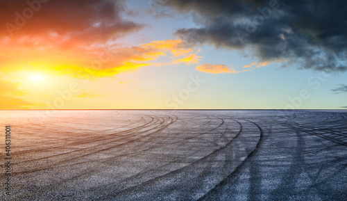 Asphalt race track road and sky clouds at sunset.Road ground background.