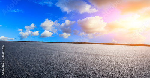 Asphalt road and sky clouds at sunset.Road background. © ABCDstock