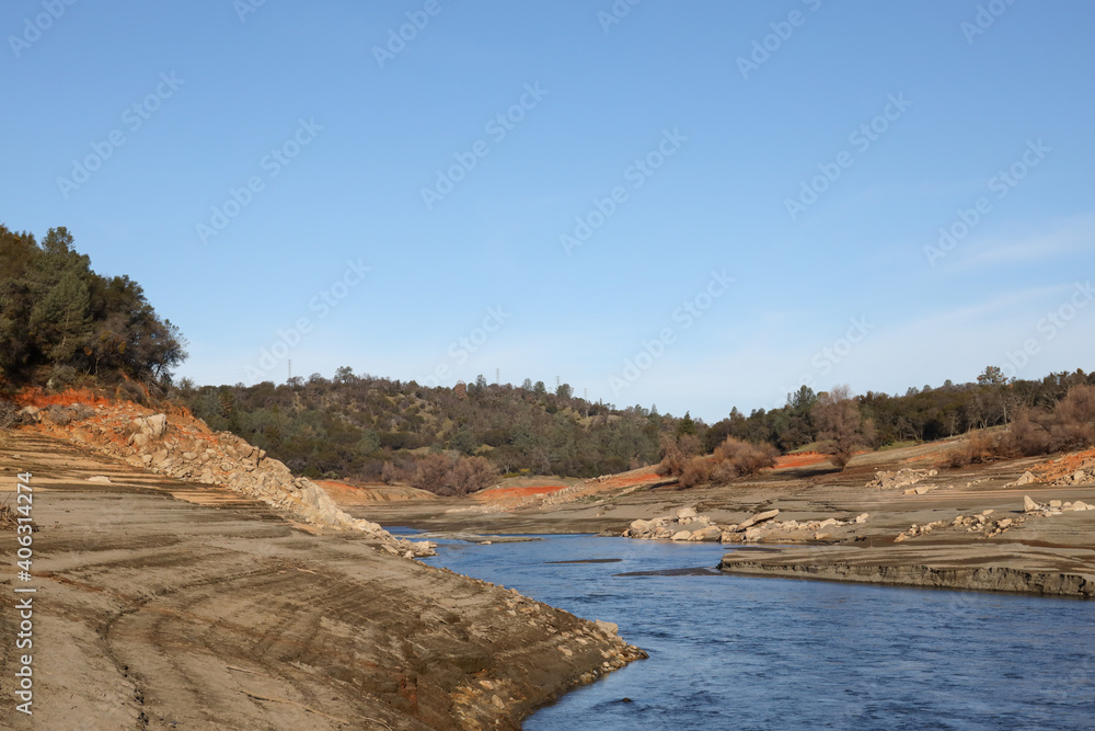 Beautiful Red Rock and Shoreline of the North Fork of the American River at Low Water Below the Folsom Reservoir High Water Line Beautiful Red Rock and Shoreline of the North Fork of the American River at Low Water Below the Folsom Reservoir High Water Line