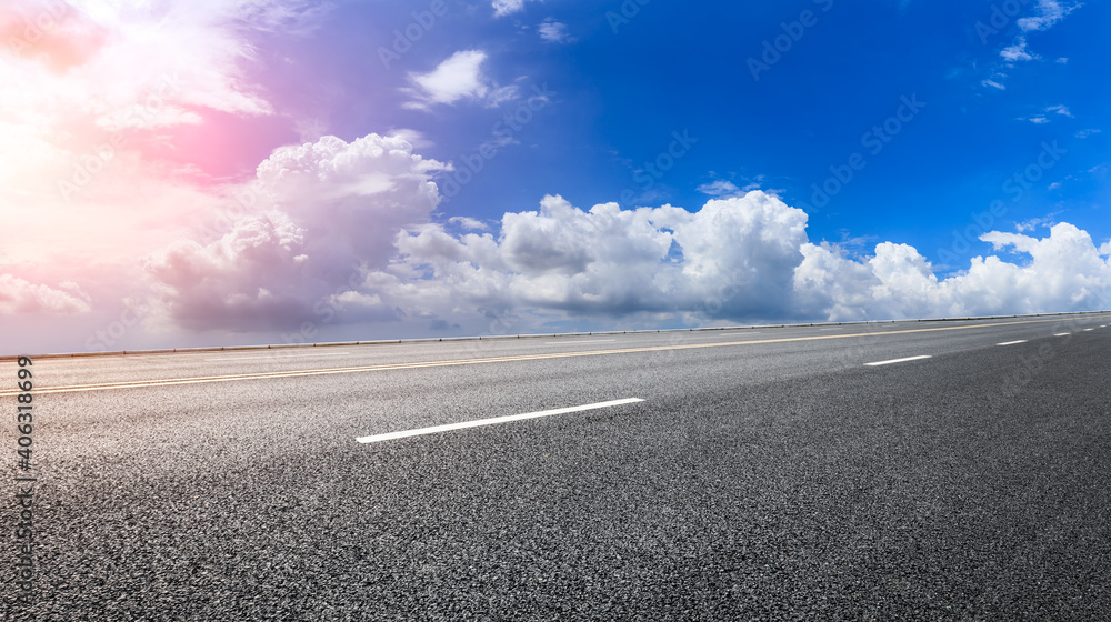 Fototapeta premium Empty asphalt road and blue sky with white clouds.Road background.