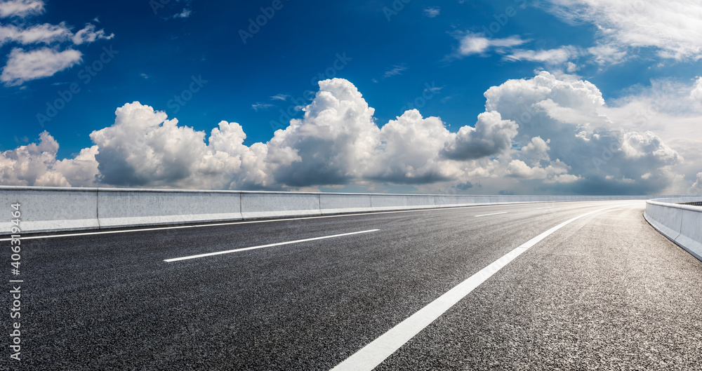 Fototapeta premium Empty asphalt road and blue sky with white clouds.Road background.