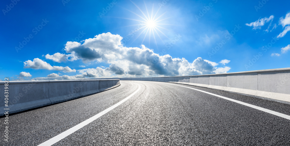 Fototapeta premium Empty asphalt road and blue sky with white clouds.Road background.