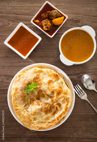 Roti Parata or Roti canai with lamb curry sauce.