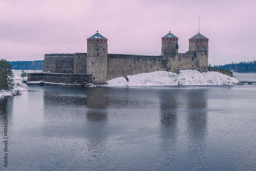 View of the ancient Olavinlinna fortress on a cloudy March evening. Savonlinna, Finland