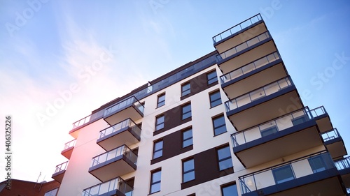 Fragment of modern luxury residential apartment, home house building concept. Modern apartment building on a sunny day with a blue sky.