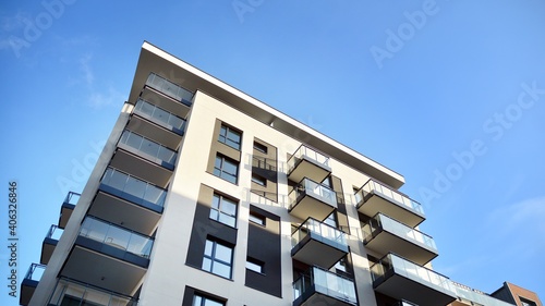 Fragment of modern luxury residential apartment,  home house building concept. Modern apartment building on a sunny day with a blue sky. © Grand Warszawski