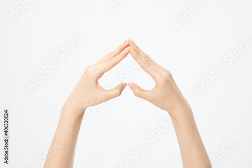 Closeup shot of hands showing a heart upside down isolated on a white background photo