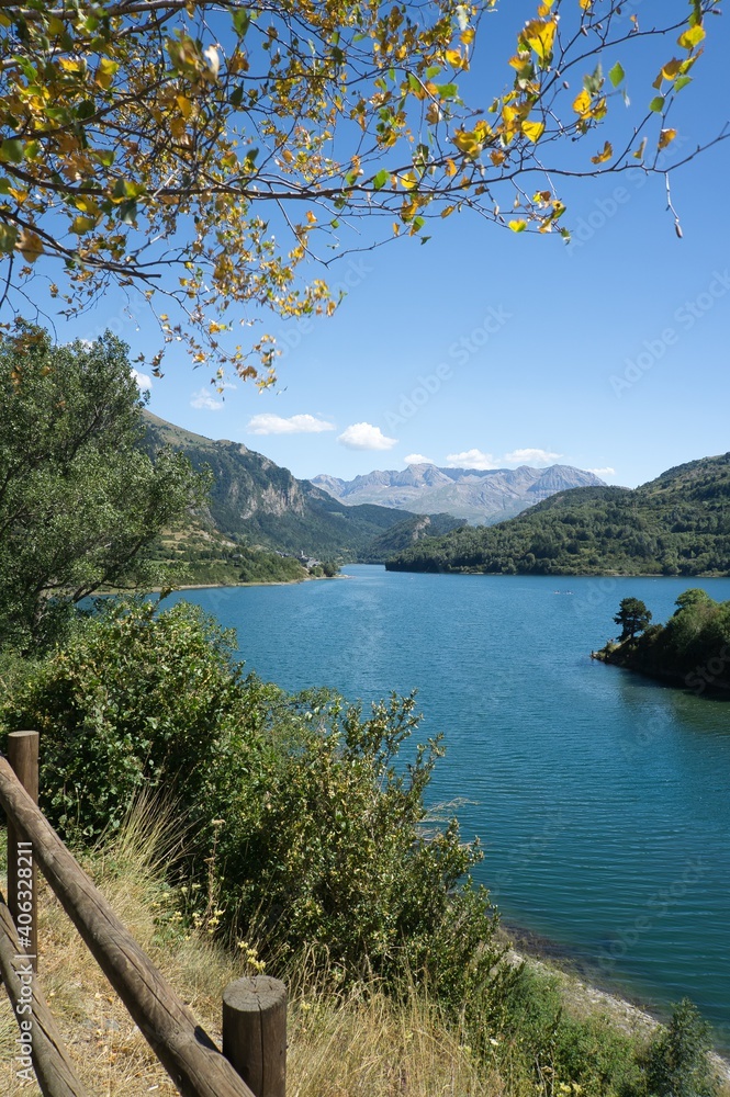 views of the town of Lanuza from the viewpoint. Large lake with mountains in the background.