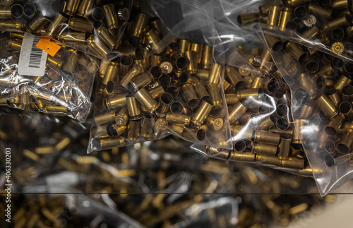 Slika na platnu Empty brass pistol cartridges, ammo in bulk on display at a gun shop, ammunition