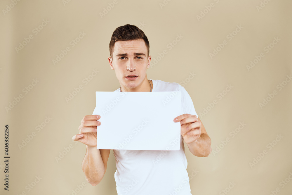 man in white t-shirt sheet of paper in hands Copy Space cropped view beige background man in white t-shirt sheet of paper in hands Copy Space cropped view beige background