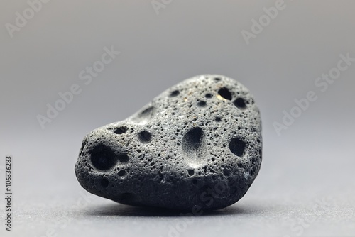 Smoke whirling around small meteorite stone photo