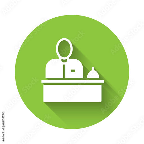White Receptionist standing at hotel reception desk icon isolated with long shadow. Green circle button. Vector.