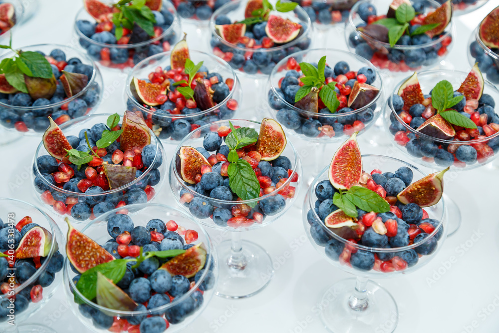 Fototapeta premium Raspberries, blackberries and blueberries. There are wonderful and delicious berries in a glass plate. Healthy and wholesome food