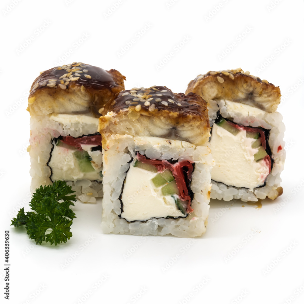 A set of three rolls dragon with eel. Sprinkled with sesame seeds. The decoration is a sprig of curly parsley. Close-up. Isolated over white background. A set of three rolls dragon with eel. Sprinkled with sesame seeds. The decoration is a sprig of curly parsley. Close-up. Isolated over white background.