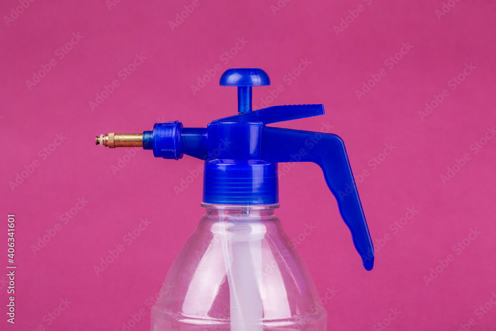 Blue spray with transparent bottle on a lilac background Blue spray with transparent bottle on a lilac background