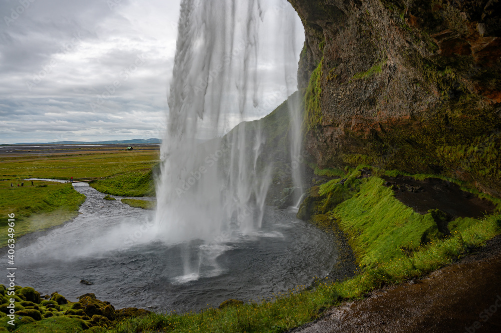 seljalandsfoss waterfall in iceland on cloudy day.
