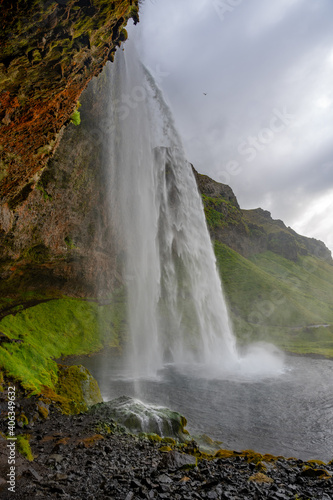 seljalandsfoss waterfall in iceland on cloudy day. © Kevin