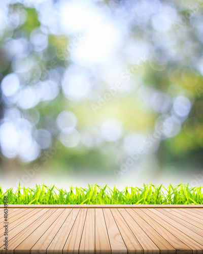 Wood floor fresh grass on a blurred bokeh nature background And spaces for placing the product concept ideas that are environmentally friendly Vertical